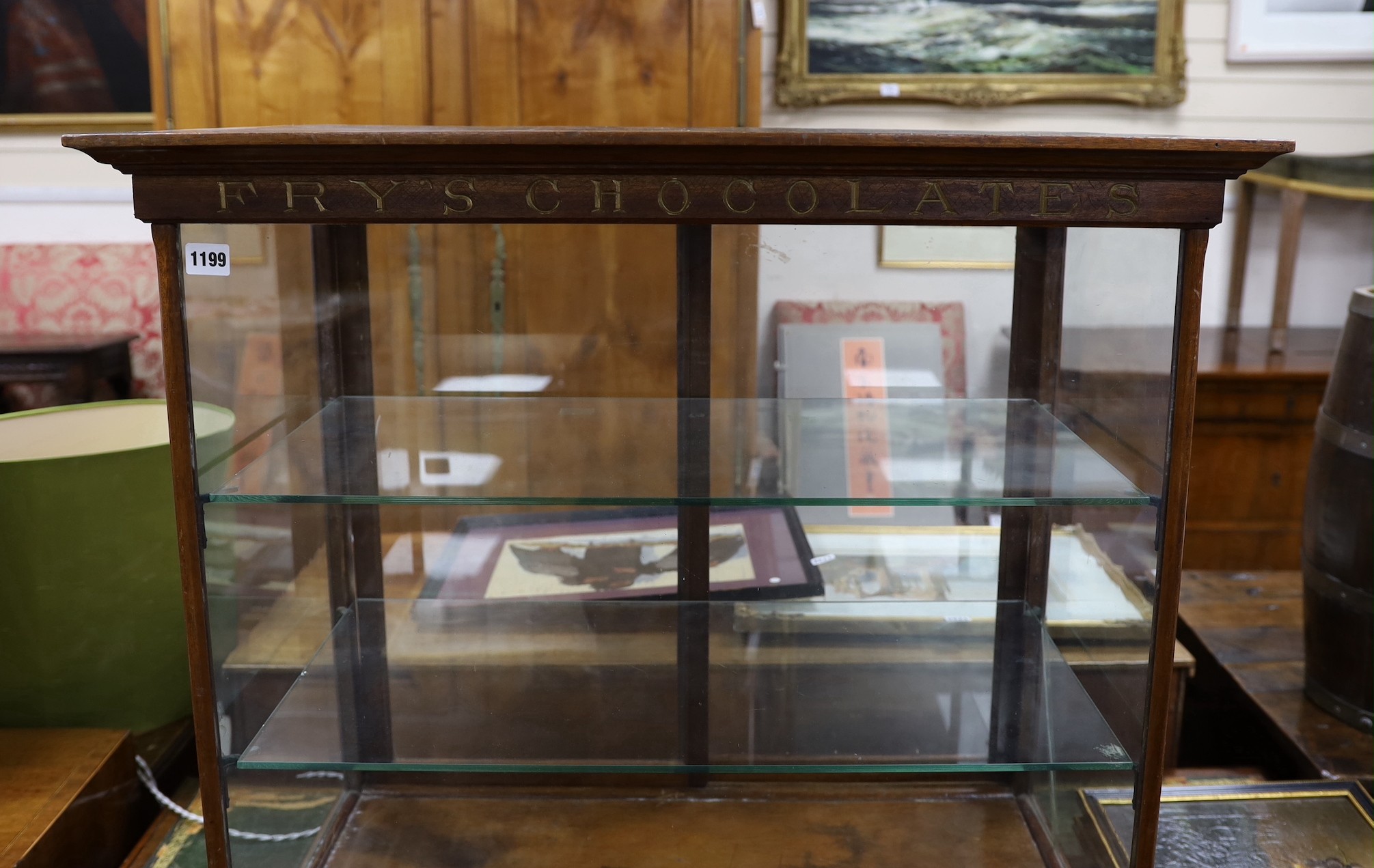 A late Victorian / Edwardian mahogany Fry’s Chocolates counter shop display cabinet with gilded lettering, width 81cms, depth 47cms, height 77cms.